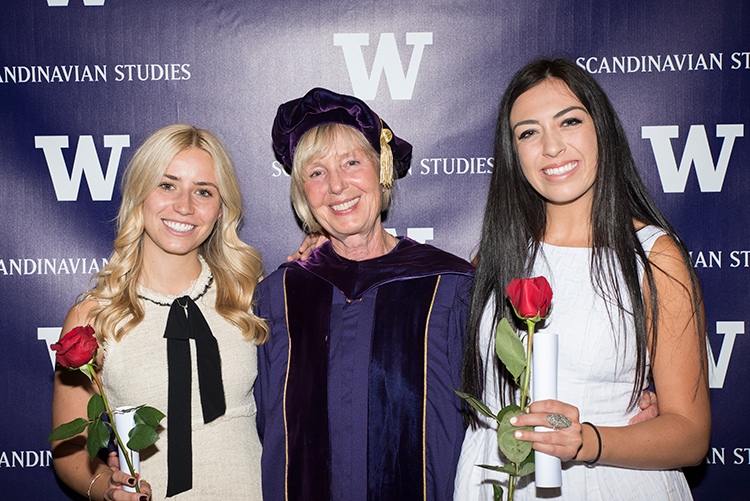 Undergraduate students receive their diplomas at the department graduation reception with Senior Lecturer Emerita Ia Dubois.