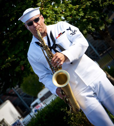 Navy musician Jay Gillespie in uniform, playing his saxophone