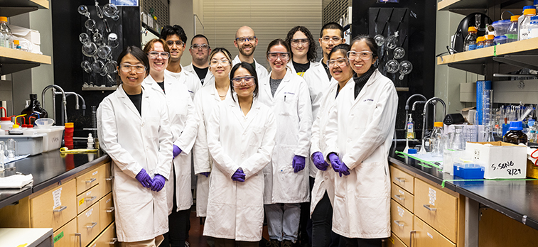 A group of UW Chemistry students in class posing in lab.