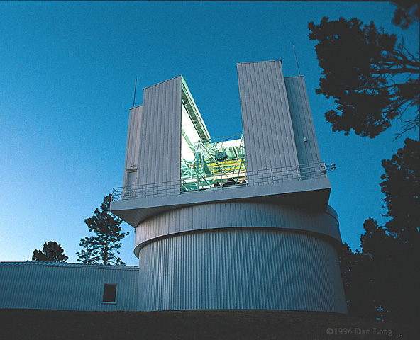 Telescope building with round base and opening for telescope in top half.
