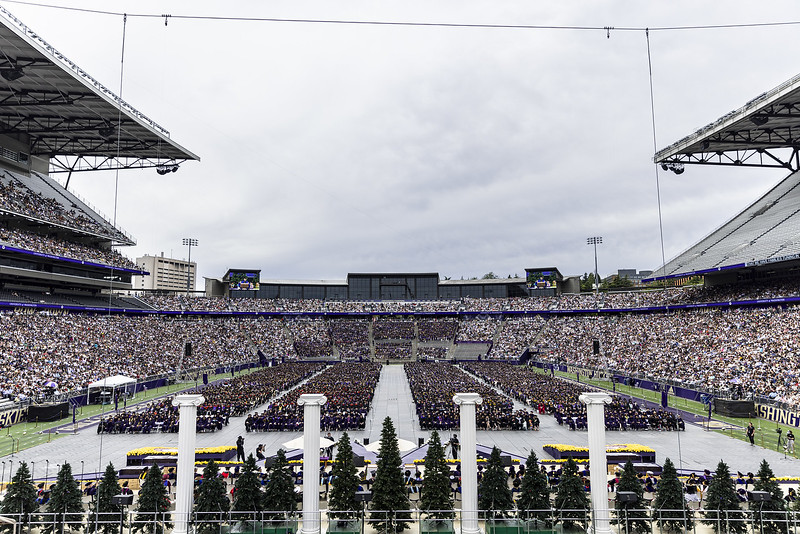 A wide-angle view of the 2024 graduation ceremony taking place in a packed Husky Stadium.