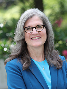 Headshot of Dean Dianne Harris in a blue suit.