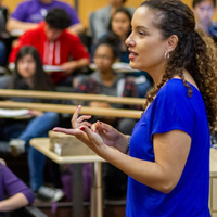 Professor speaking in front of students in a classroom