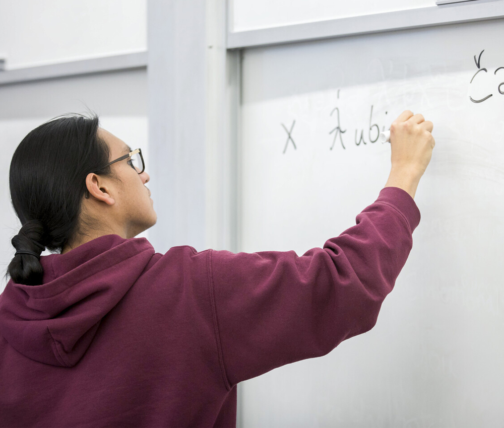 Student writing on a whiteboard