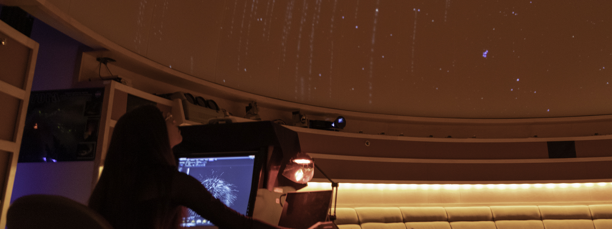 A student looks at projected stars using a computer in the UW Planetarium