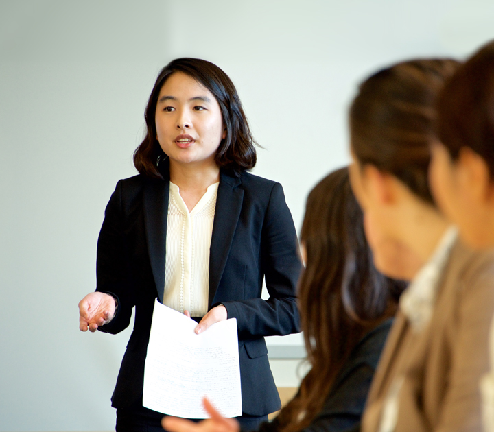 Student gives formal presentation in professional attire. 