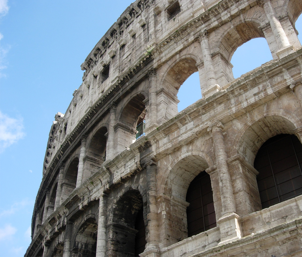 Part of the Roman Coliseum on a clear day.