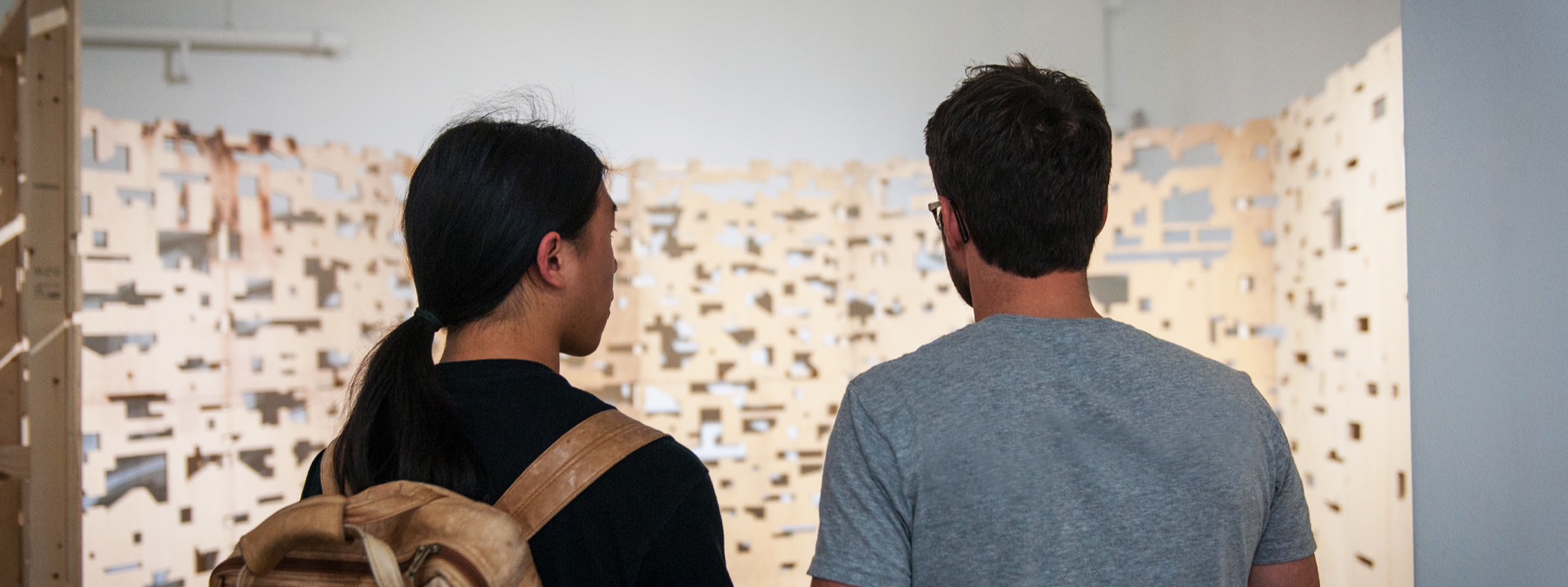 Two students looking at an art installation