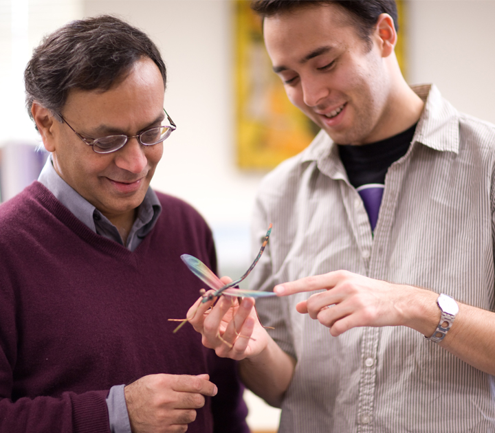 Two researchers discussing equipment