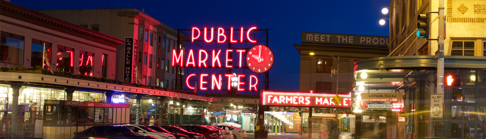 The main entrance to Pike Place Market lit up at night.