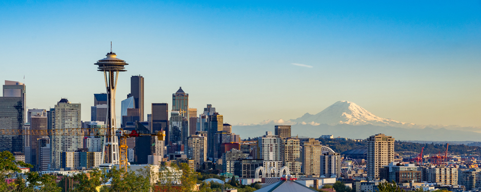 Downtown Seattle's skyline with the Space Needle, skyscrapers, and Mt. Rainier.