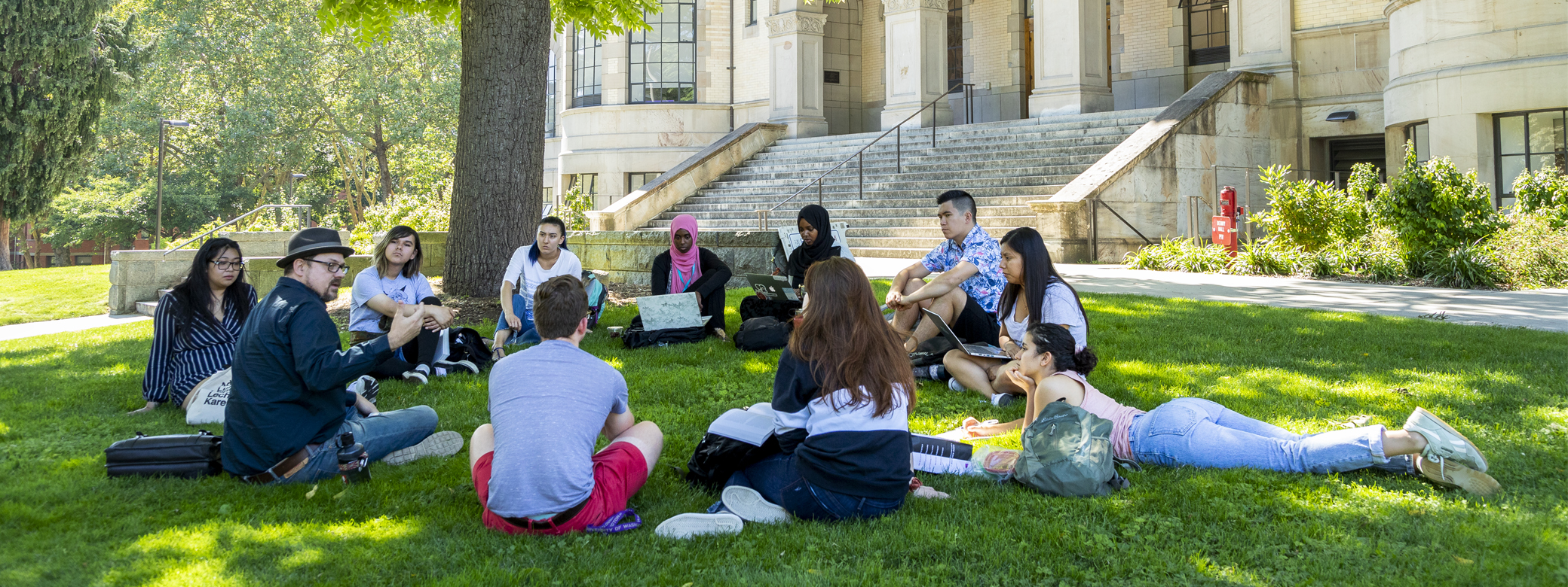 A group of students conversing on in front of Parrington Hall.