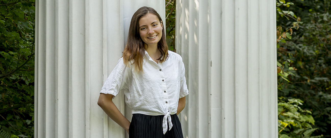 Allison Dumitriu Corcoana standing in front of the columns in UW's Sylvan Grove.