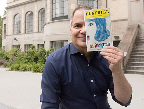 David Armstrong holding up a theater Playbill 