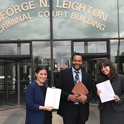 David Owens with his students outside courthouse, celebrating a successful case.