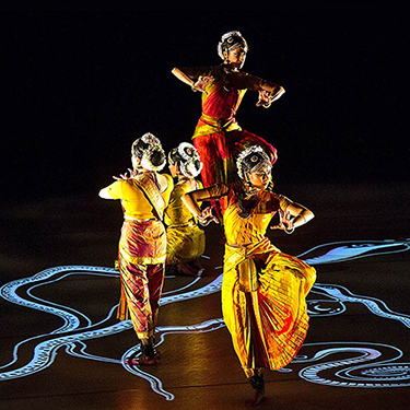 Ragamala dancers performing in brightly colored clothing.