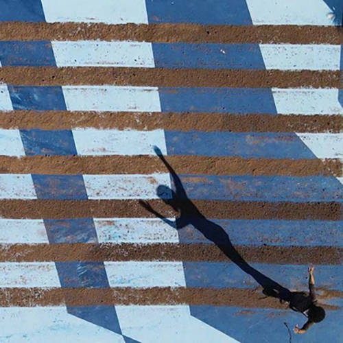 Ariel Rene Jackson art project in pool, with stripes of sand and shadows.