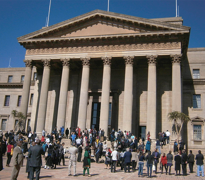 People gathered in front of building with columns in South Africa