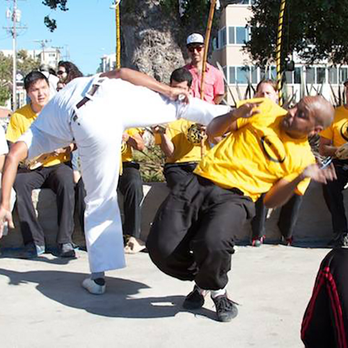 Two dancers performing capoeira