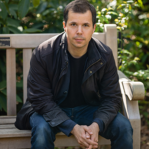 Huck Hodge sitting on a bench on campus. 