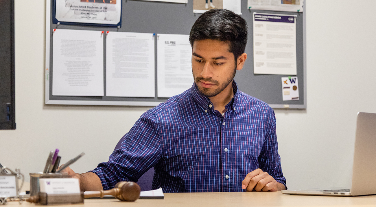 Osman Salahuddin working at his ASUW office desk.