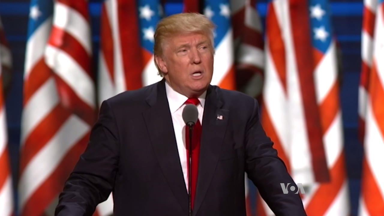 Donald Trump speaking in front of American flag