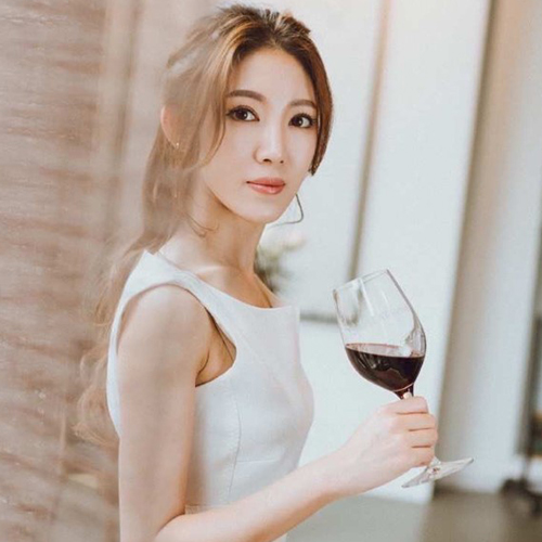 Danni Lin holding glass of red wine