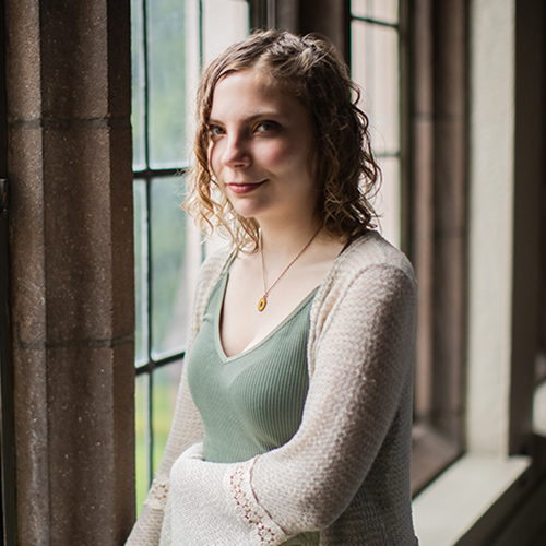Darby Sherwood stands by a window in UW's Hutchinson Hall. 