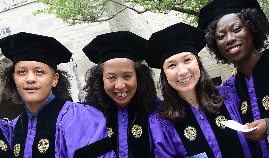 Kemi Adeyemi, Jasmine Mahmoud, colleague Colleen Daniher, and Nikki Yeboah in caps and gowns after receiving their PhDs at Northwestern University.