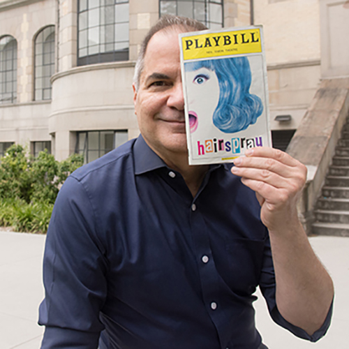 David Armstrong holding up a Playbill for the musical Hairspray