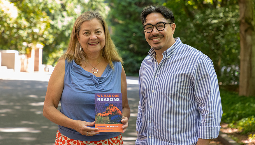 Ricardo Ruiz with Frances McCue, who is holding his poetry book.