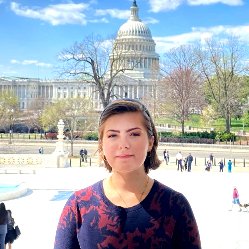 Lillian Williamson in Washington, DC, with the Capitol Building visible in the distance.