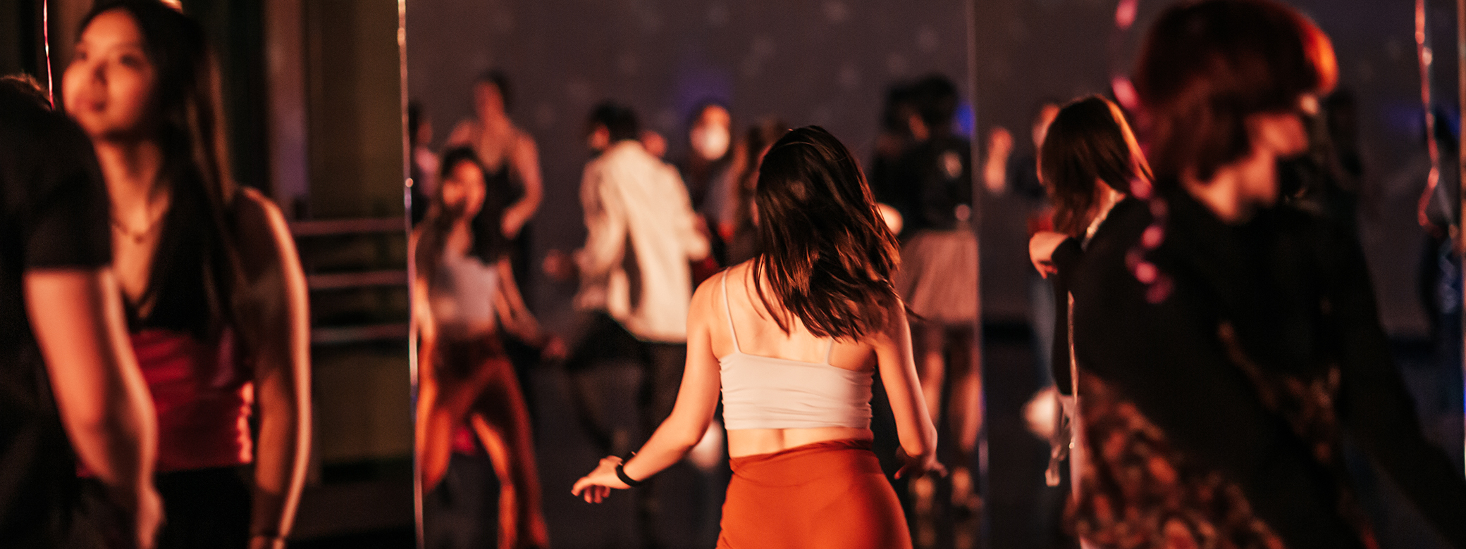 Students dancing in Club Classroom, a UW dance studio decorated as a dance club.