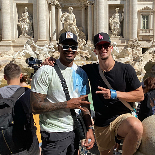 Husky football players pose in from of the Trevi Fountain in Rome.