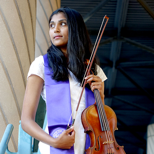 Meghna Shankar holding a viola and bow