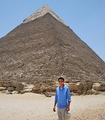 Alex Minami in Egypt, dwarfed by a pyramid behind him.