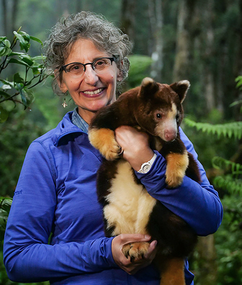 Lisa Dabek holding a young tree kangaroo in her arms.