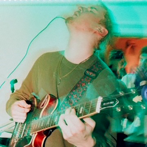 Markus Teuton playing guitar on stage