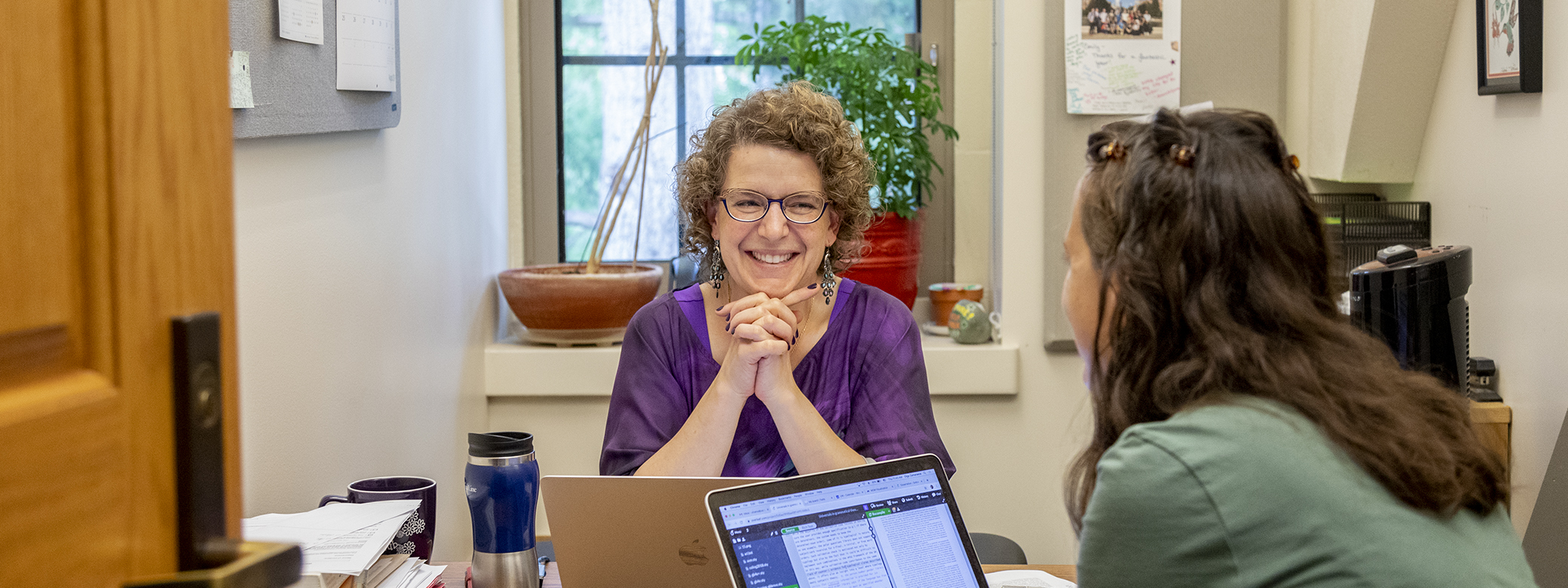 Professor Emily Bender talking with a student in her office. 