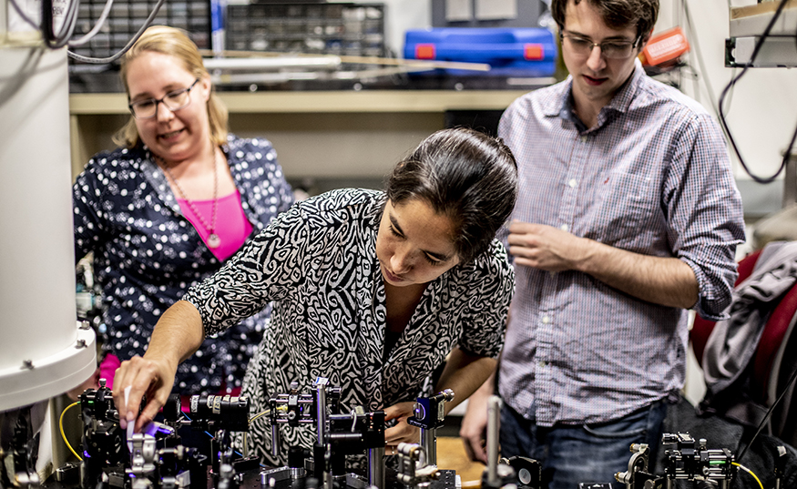 Kai-Mei Fu working adjusting equipment for an quantum experiment in a UW lab. 