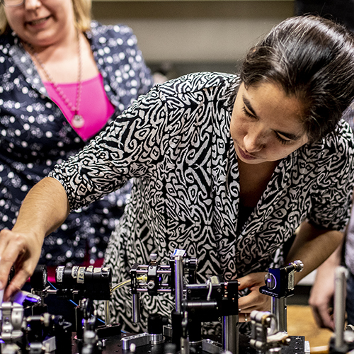 Professor Kai-Mei Fu preparing a quantum experiment in a lab.