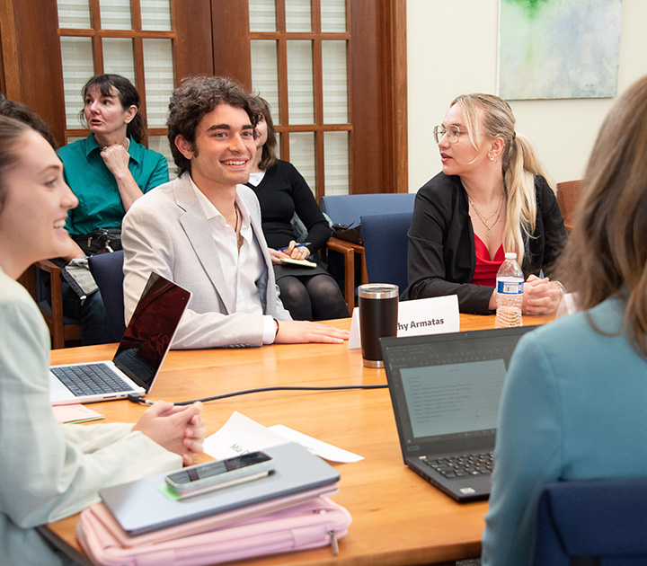 Students talking around a large table