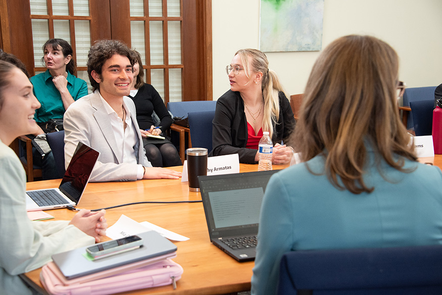 Students talking around a large table