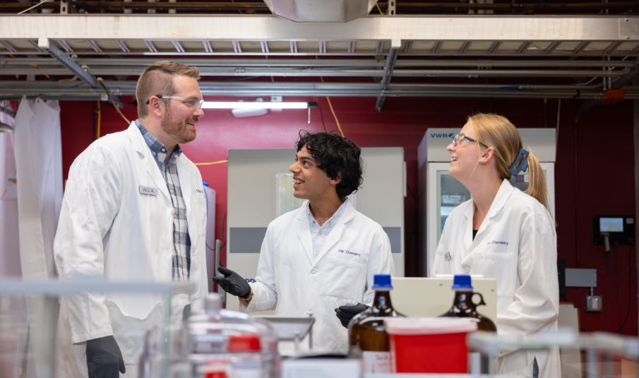 “Basic research lays the foundation that allows creative real-world solutions to be born,” says Nick Riley (left), talking with undergraduate Vishnu Rajan, a summer intern, and doctoral student Kayla Markuson. Photo by Juan Rodriguez.