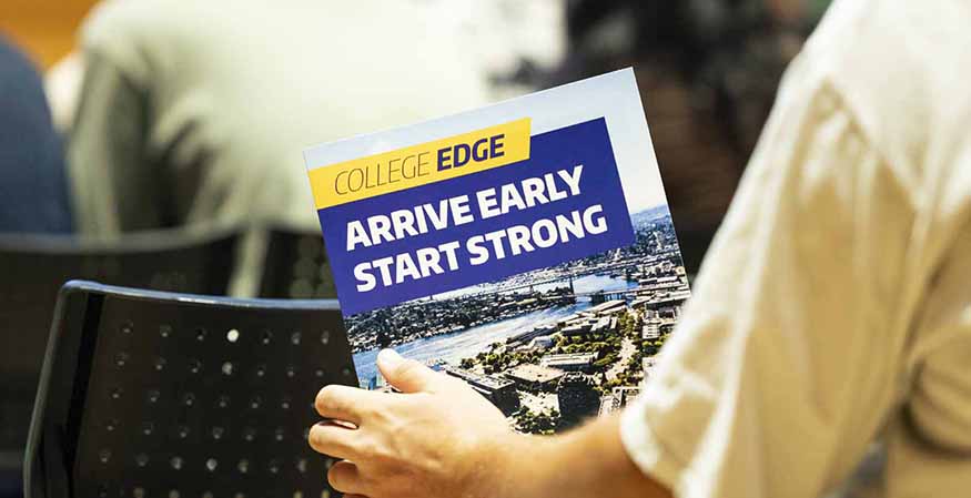 Student holding a College Edge brochure, with the message "Arrive Early, Start Strong" visible on the front.