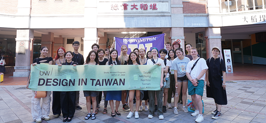 Large group of students holding up a banner that reads "UW Design in Taiwan."