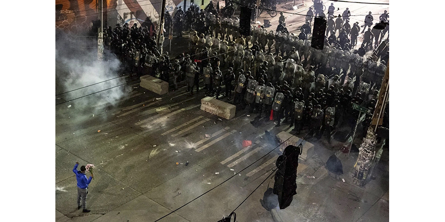 A protester facing a line of police during the CHOP protests.