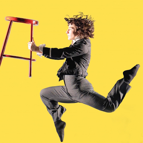 Dancer leaping, holding a red metal stool