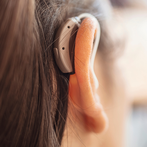 Close up of an ear with a hearing aid.