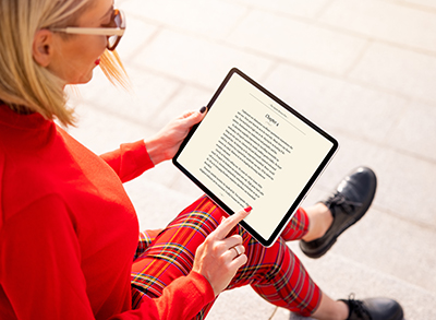 A woman holding an electronic tablet to read a book. 